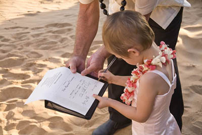 renew wedding vows on maui as girl signs certificate
