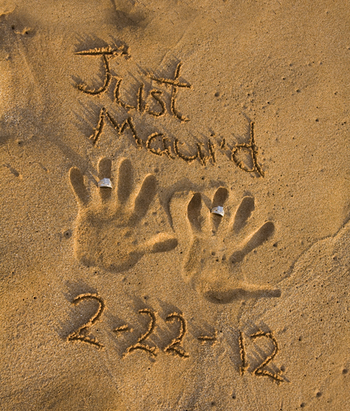rings and hand print in the sand at lesbian maui wedding