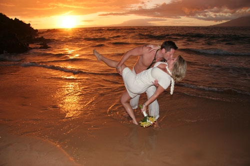 Romantic maui wedding couple kissing after their island beach wedding