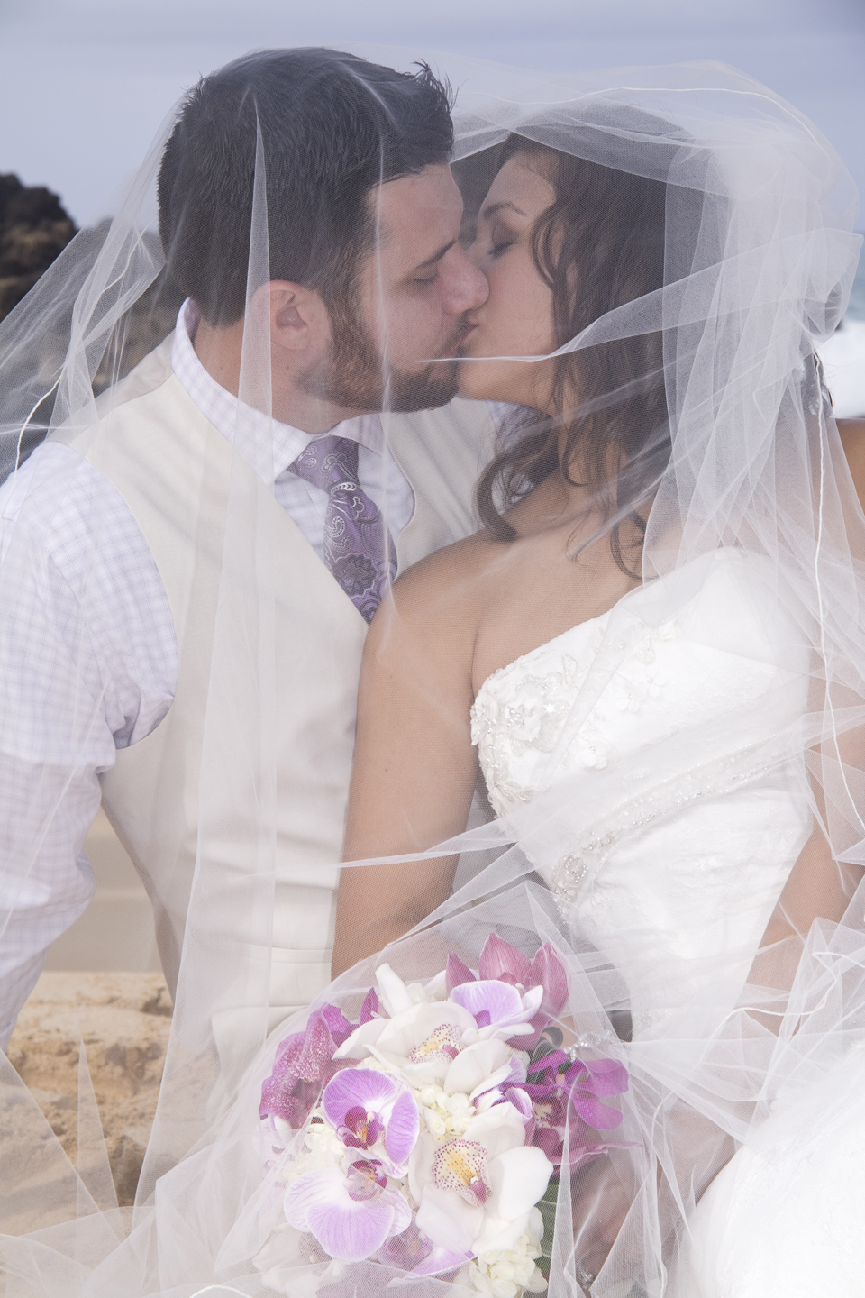 kissing through veil at Hawaii Wedding and Vow Renewal