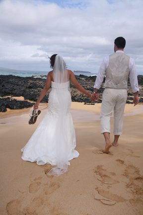 couple walks away from Maui Wedding