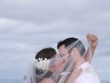 bride kissing groom through veil