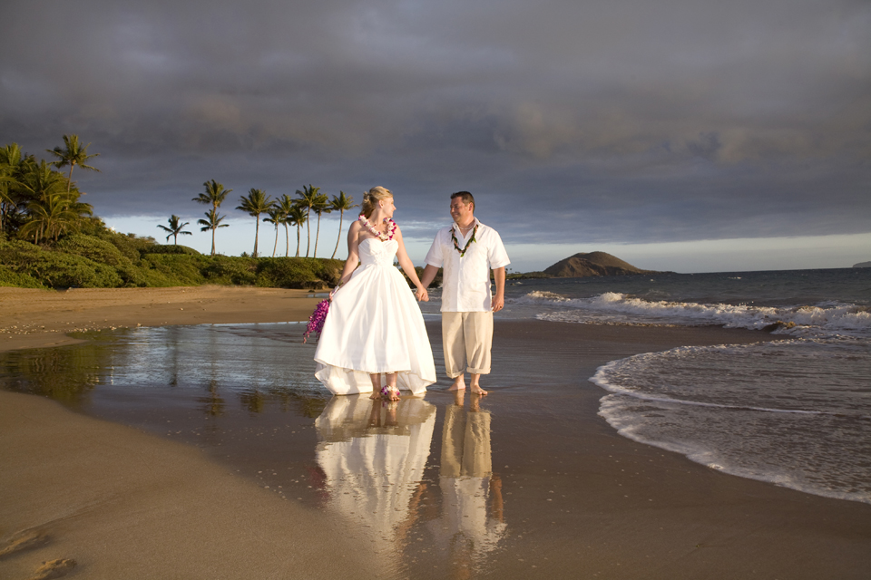 strolling couple at maui beach wedding