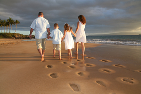 family walking on the beach at their vow renewal on maui