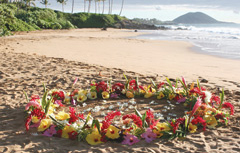 tropical flowers form a circle for wedding decorations on a Maui beach