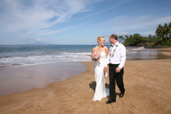 loving couple walk on Poolenalena Beach, Makena Maui for their wedding