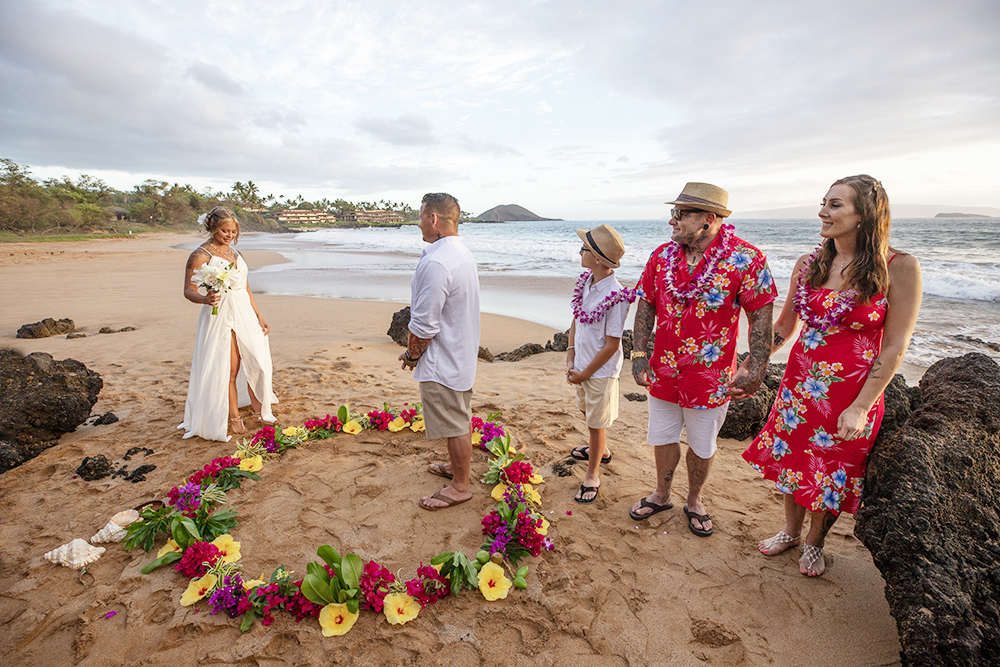 hawaii bride on maui steppinging into flower circle, beach decorations